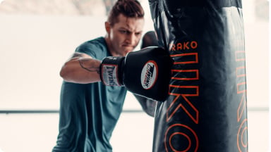 Boxer throwing a punch at a heavy bag during a boxing workout