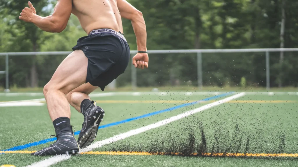 Athlete running football drills on a field during a training session