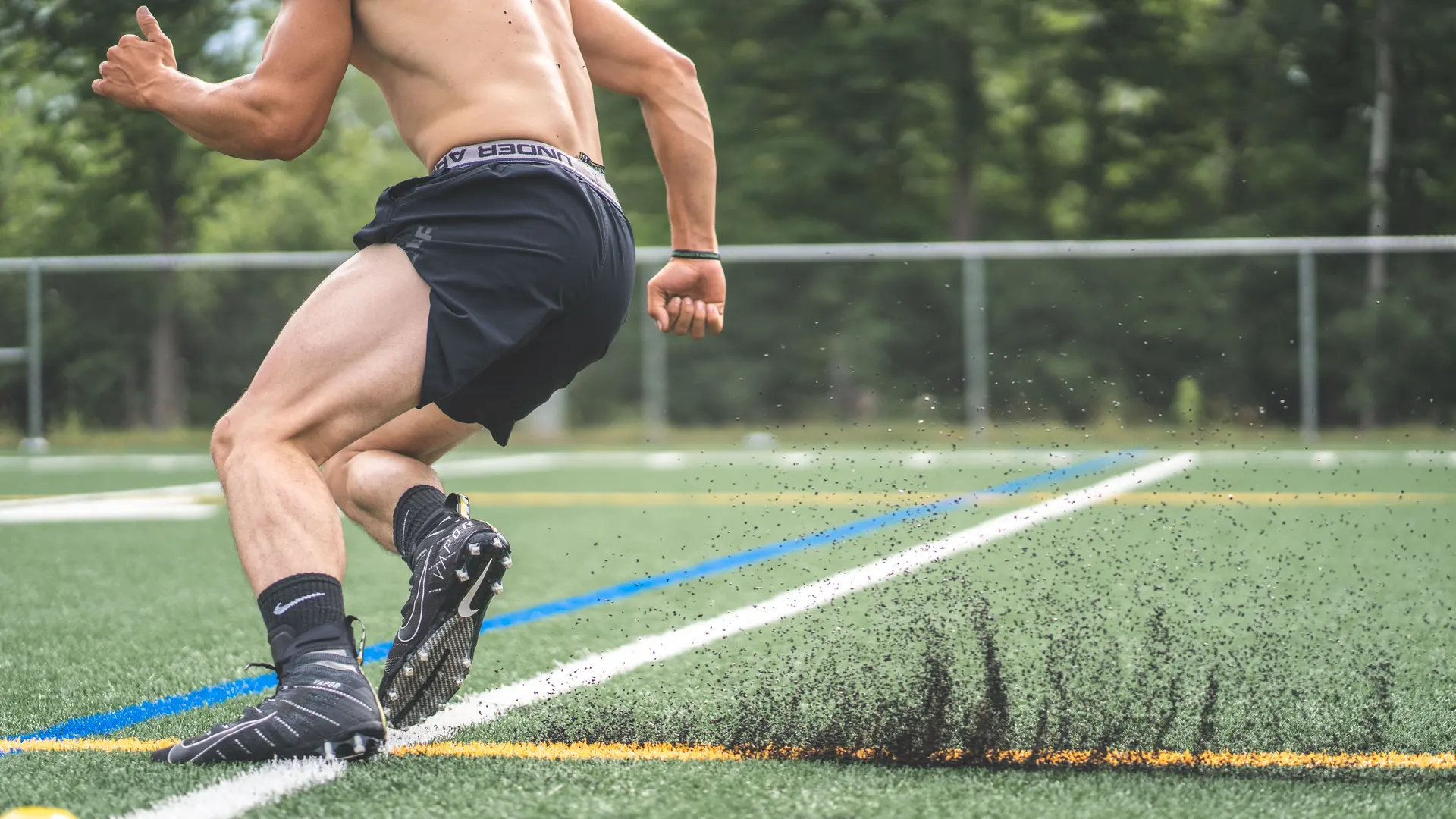 Athlete running football drills on a field during a training session